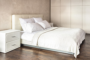 comfortable white bed with white pillows and linens in a hotel
