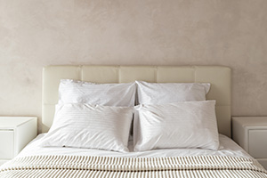 White prepared big bed with four pillows in a hotel 