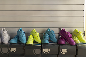 Sport shoe shop: multicolor fitness shoes in the row on their boxes for sale with a space for text writing