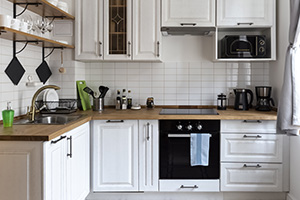 White kitchen furniture: equipped counter with appliances